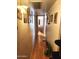 Long hallway with laminate flooring and decorative wall art at 5136 E Evergreen St # 1053, Mesa, AZ 85205