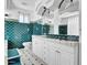 Bright bathroom featuring white cabinetry, ornate mirrors, and teal tile accents at 538 S Macdonald --, Mesa, AZ 85210
