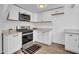 Well-lit kitchen showcasing white cabinets, stainless steel oven and a decorative floor mat at 538 S Macdonald --, Mesa, AZ 85210