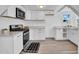 Modern kitchen with white cabinets, stainless steel appliances, and stylish flooring at 538 S Macdonald --, Mesa, AZ 85210