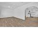 Open-concept living area with laminate flooring seamlessly connecting to the modern kitchen at 538 S Macdonald --, Mesa, AZ 85210
