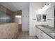 Well-lit bathroom featuring granite counters, tile floors and a stone shower at 705 W Country Estates Ave, Gilbert, AZ 85233