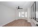Bright bedroom features wood look flooring, neutral colored walls, a ceiling fan, and bay windows at 705 W Country Estates Ave, Gilbert, AZ 85233