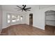 Open bedroom features wood floors, ceiling fan, bay window and ensuite bathroom entrance at 705 W Country Estates Ave, Gilbert, AZ 85233
