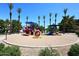 Community playground with modern equipment and palm trees for shade at 705 W Country Estates Ave, Gilbert, AZ 85233