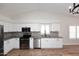 Bright kitchen features stainless steel appliances, granite countertops, a grey backsplash, and plenty of white cabinets at 705 W Country Estates Ave, Gilbert, AZ 85233