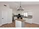 Modern kitchen with wood floors, white cabinets, stainless steel appliances, and a butcher block island at 705 W Country Estates Ave, Gilbert, AZ 85233