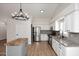 Bright kitchen features a butcher block island, stainless steel appliances, granite countertops, and wood look flooring at 705 W Country Estates Ave, Gilbert, AZ 85233