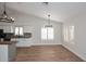 Bright living space with wood floors, modern lighting, and view of the open-concept kitchen and dining area at 705 W Country Estates Ave, Gilbert, AZ 85233