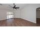 Spacious bedroom featuring wood flooring, a ceiling fan, and sliding glass doors with natural light at 705 W Country Estates Ave, Gilbert, AZ 85233