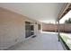 Covered patio with tile flooring, sliding glass door, and view of the backyard at 705 W Country Estates Ave, Gilbert, AZ 85233