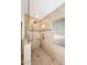 Modern stone shower with built-in bench, rainfall shower head, and a window at 705 W Country Estates Ave, Gilbert, AZ 85233