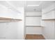 Walk-in closet with wood floors and white shelving on all sides at 705 W Country Estates Ave, Gilbert, AZ 85233