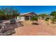 Brick-paved back patio and landscaped yard featuring a built-in grill area for outdoor dining and entertaining at 7403 W Montebello Ave, Glendale, AZ 85303