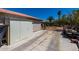 A spacious backyard featuring a metal storage shed, concrete drive, and desert landscaping at 7403 W Montebello Ave, Glendale, AZ 85303