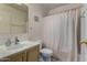 Standard bathroom with a shower-tub combination and a white toilet and sink at 7403 W Montebello Ave, Glendale, AZ 85303
