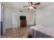 Spacious bedroom featuring a ceiling fan, neutral walls, and tile flooring at 7403 W Montebello Ave, Glendale, AZ 85303