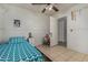 Cozy bedroom featuring a ceiling fan, comfortable bed and tile flooring at 7403 W Montebello Ave, Glendale, AZ 85303