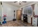 Bright bedroom with tile flooring, a built-in desk, and ample space for various activities at 7403 W Montebello Ave, Glendale, AZ 85303