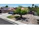Charming single-Gathering home with a well-manicured lawn, mature tree, brick driveway, and fenced entry at 7403 W Montebello Ave, Glendale, AZ 85303