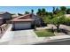 Inviting single-story home featuring a two-car garage, manicured lawn, and mature landscaping at 7403 W Montebello Ave, Glendale, AZ 85303