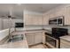 A well-equipped kitchen boasts modern appliances and ample cabinet storage at 7403 W Montebello Ave, Glendale, AZ 85303