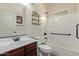 Bathroom view with single sink, wood cabinets, and tub with shower at 7726 E Baseline Rd # 125, Mesa, AZ 85209