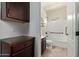 Bathroom view with dark wood cabinet, countertop, and tub with shower at 7726 E Baseline Rd # 125, Mesa, AZ 85209