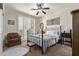 Serene bedroom featuring a cozy bed, ceiling fan, and bright natural light at 7726 E Baseline Rd # 125, Mesa, AZ 85209