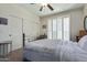Comfortable bedroom with a ceiling fan, sliding door closet, and plantation shutters at 7726 E Baseline Rd # 125, Mesa, AZ 85209