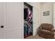 Bedroom closet with sliding doors, wood shelf, and a variety of clothing at 7726 E Baseline Rd # 125, Mesa, AZ 85209