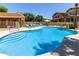 Large community pool featuring stairs for easy access and surrounded by lounge chairs for relaxing and socializing at 7726 E Baseline Rd # 125, Mesa, AZ 85209