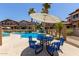 Community pool surrounded by inviting lounge chairs and palm trees, perfect for relaxing in the sun at 7726 E Baseline Rd # 125, Mesa, AZ 85209