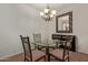 Cozy dining area with a glass table, four chairs, and an ornate mirror at 7726 E Baseline Rd # 125, Mesa, AZ 85209