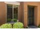 Charming townhouse entrance with a security door, desert landscaping and nearby window at 7726 E Baseline Rd # 125, Mesa, AZ 85209