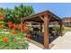 A community grilling area with a wooden gazebo and two barbecues, perfect for outdoor gatherings at 7726 E Baseline Rd # 125, Mesa, AZ 85209