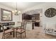 Open kitchen and dining area featuring granite countertops and dark wood cabinets at 7726 E Baseline Rd # 125, Mesa, AZ 85209