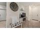 Open living area featuring neutral colors, comfortable seating, and a decorative wall clock at 7726 E Baseline Rd # 125, Mesa, AZ 85209