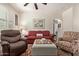 Relaxing living room with a ceiling fan, plush seating, and a decorative coffee table at 7726 E Baseline Rd # 125, Mesa, AZ 85209
