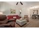 Relaxing living room with a ceiling fan, plush seating, and a decorative coffee table at 7726 E Baseline Rd # 125, Mesa, AZ 85209
