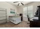 Office features plantation shutters, ceiling fan, and dark colored furniture at 7726 E Baseline Rd # 125, Mesa, AZ 85209