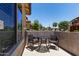 Inviting outdoor patio featuring a table and two chairs, perfect for relaxing and enjoying the neighborhood view at 7726 E Baseline Rd # 125, Mesa, AZ 85209