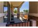 Relaxing outdoor patio with seating, a grill, and a view of the well-manicured landscaping and nearby homes at 7726 E Baseline Rd # 125, Mesa, AZ 85209