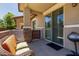 A cozy patio with an outdoor wicker chair and access to the home through a sliding glass door at 7726 E Baseline Rd # 125, Mesa, AZ 85209
