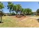 Community playground with slide, climbing wall, and play structure on a well-maintained lawn at 7726 E Baseline Rd # 125, Mesa, AZ 85209