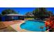 Sparkling backyard pool with a brick patio, lush landscaping, and a barbecue area for outdoor entertaining at 846 E Ocotillo Rd, Phoenix, AZ 85014
