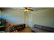 Bright bedroom with a ceiling fan, hardwood floors and a gray couch at 846 E Ocotillo Rd, Phoenix, AZ 85014