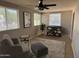 Inviting living room featuring a ceiling fan, cozy seating, decorative shelves, and lots of natural light at 846 E Ocotillo Rd, Phoenix, AZ 85014