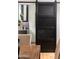 Stylish black barn door with a modern design, adding a touch of rustic charm to the interior at 8708 E Rancho Vista Dr, Scottsdale, AZ 85251