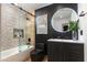 Stylish bathroom with patterned tile shower, sleek black fixtures, and elegant, lighted mirror at 8708 E Rancho Vista Dr, Scottsdale, AZ 85251